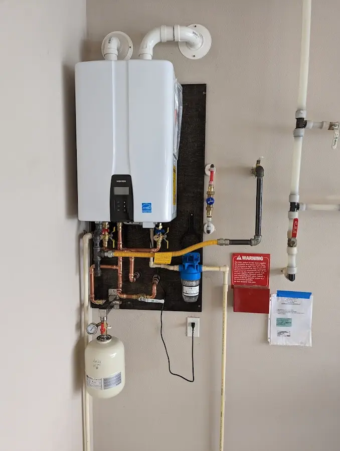 Professional plumber installing copper piping in a Gateway home